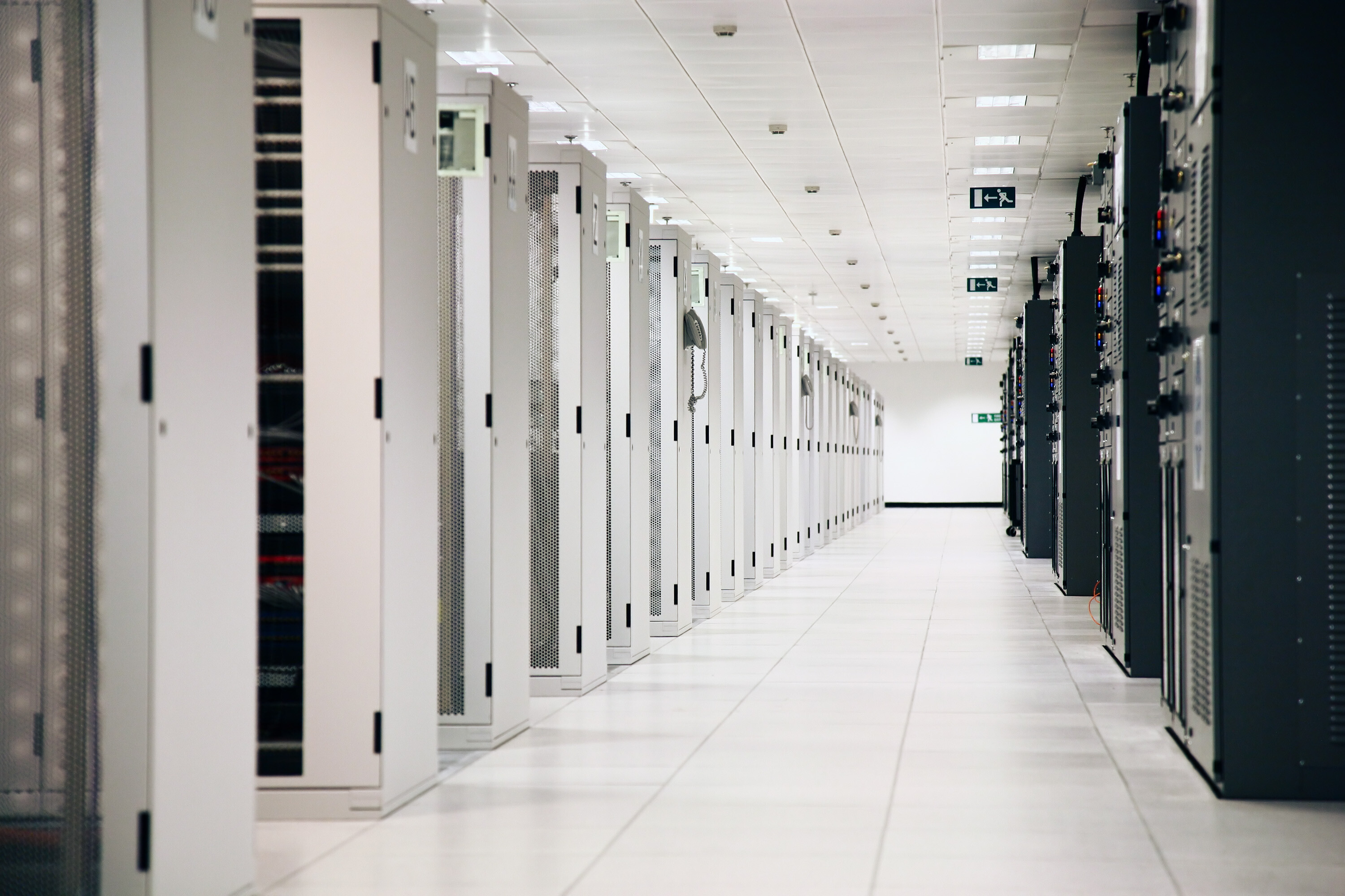 Several rows of data center cabinets in a data center environment.